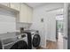 Laundry room with Samsung washer and dryer and lots of cabinets at 9405 Ashley Dr, Weeki Wachee, FL 34613