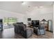 Cozy living room with hardwood floors, tv, and an arcade game at 9405 Ashley Dr, Weeki Wachee, FL 34613