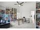 Bright living area features built-in shelving, neutral carpeting, modern ceiling fan, table, and comfortable seating at 9405 Ashley Dr, Weeki Wachee, FL 34613