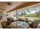 The screened-in patio features a pond and multiple seating areas, creating a serene outdoor living space at 9405 Ashley Dr, Weeki Wachee, FL 34613