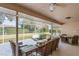 Screened patio boasts a ceiling fan, pond, and comfortable seating areas, perfect for relaxing or entertaining at 9405 Ashley Dr, Weeki Wachee, FL 34613