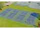 Aerial view of pickleball courts showcases a fun community activity and a beautiful landscaped setting at 9405 Ashley Dr, Weeki Wachee, FL 34613