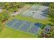 Aerial view of multiple pickleball courts and tennis courts in a well-maintained community at 9405 Ashley Dr, Weeki Wachee, FL 34613