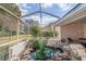 The screened lanai has a serene pond surrounded by lush greenery, creating a peaceful retreat at 9405 Ashley Dr, Weeki Wachee, FL 34613
