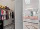 Spacious walk-in closet with shelving and an adjoining bathroom at 9405 Ashley Dr, Weeki Wachee, FL 34613