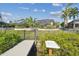 Beautifully landscaped backyard with lush tropical foliage, lanai, fence, and private dock access at 944 Symphony Isles Blvd, Apollo Beach, FL 33572