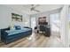 Bedroom with a daybed, desk, and large window with sheer white curtains at 944 Symphony Isles Blvd, Apollo Beach, FL 33572