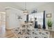 Coastal dining room featuring chandelier, table with seating for four, and anchor themed rug at 944 Symphony Isles Blvd, Apollo Beach, FL 33572