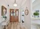 Elegant foyer with hardwood flooring, decorative accents, and a glimpse into the home's interior at 944 Symphony Isles Blvd, Apollo Beach, FL 33572