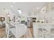 Bright kitchen featuring stainless steel appliances, white cabinetry, and a spacious breakfast bar at 944 Symphony Isles Blvd, Apollo Beach, FL 33572