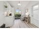 Kitchenette featuring white cabinetry, a charming window with view of the garden, and a cozy seating area at 944 Symphony Isles Blvd, Apollo Beach, FL 33572