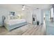 Comfortable main bedroom with light blue walls, ceiling fan, and closet space at 944 Symphony Isles Blvd, Apollo Beach, FL 33572