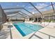 Inviting pool with a screened enclosure, providing a refreshing escape and a picturesque view of the backyard and home at 944 Symphony Isles Blvd, Apollo Beach, FL 33572
