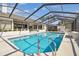 Sparkling pool with screened enclosure, offering a refreshing and private outdoor oasis for relaxation and recreation at 944 Symphony Isles Blvd, Apollo Beach, FL 33572