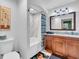 Bathroom showcasing bathtub, white marble shower, modern cabinets, and granite countertops at 100 4Th S Ave # 202, St Petersburg, FL 33701