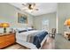 Well-lit bedroom features hardwood floors, ceiling fan, an art piece, and traditional decor at 100 4Th S Ave # 202, St Petersburg, FL 33701