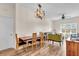 Open-concept dining and living area with modern lighting, stylish furniture, and wood floors at 100 4Th S Ave # 202, St Petersburg, FL 33701