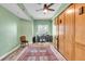 Home office space features wood floors, a ceiling fan, and a large cabinet at 100 4Th S Ave # 202, St Petersburg, FL 33701