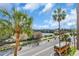 Street view from the property featuring palm trees, a road, parking, and a school bus at 100 4Th S Ave # 202, St Petersburg, FL 33701