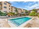 Community pool surrounded by lounge chairs, shaded cabanas, and lush landscaping at 100 4Th S Ave # 202, St Petersburg, FL 33701