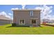 Exterior view of the home showcasing a well-maintained lawn, patio and sliding glass door access to the home at 10733 Hidden Banks Gln, Parrish, FL 34219