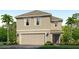 Two-story home showing the garage, front door, and landscaping at 10734 Hidden Banks Gln, Parrish, FL 34219