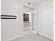 Bright bedroom with carpet and white trim looks into a bar area with dark wood cabinets through glass doors at 1120 E Kennedy Blvd # 1126, Tampa, FL 33602