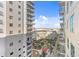 Exterior view of a modern, upscale apartment building with open-air balconies and mature landscaping below at 1120 E Kennedy Blvd # 1126, Tampa, FL 33602