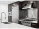 Close-up of a modern kitchen with stainless steel appliances, dark cabinets, and a white countertop at 1120 E Kennedy Blvd # 1126, Tampa, FL 33602