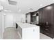 Bright kitchen with a large island, dark cabinetry, stainless steel appliances, and light tile floors at 1120 E Kennedy Blvd # 1126, Tampa, FL 33602