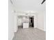 Bright and airy living room showing the kitchen, pendant lighting, and sleek flooring throughout the open-concept layout at 1120 E Kennedy Blvd # 1126, Tampa, FL 33602