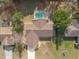 Aerial view of a home with a private, screened-in pool and a well manicured lawn at 11304 Sedgefield Ave, Spring Hill, FL 34608