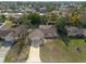 Aerial shot of home with mature trees and landscaping in a residential neighborhood at 11304 Sedgefield Ave, Spring Hill, FL 34608