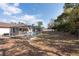 Backyard view of a lovely screened-in pool and the home with outdoor living at 11304 Sedgefield Ave, Spring Hill, FL 34608