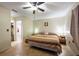 Comfortable bedroom with tiled floors, ceiling fan, and ensuite bathroom at 11304 Sedgefield Ave, Spring Hill, FL 34608