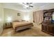 Cozy bedroom features tiled floors, ceiling fan and striped comforter on the bed at 11304 Sedgefield Ave, Spring Hill, FL 34608