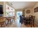 Dining area featuring a table with seating, tile floors, and access to the screened-in lanai at 11304 Sedgefield Ave, Spring Hill, FL 34608