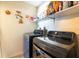 Functional laundry room with modern LG washer and dryer, and storage shelves above at 11304 Sedgefield Ave, Spring Hill, FL 34608