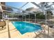 Inviting screened pool with clear blue water and lounge chairs at 11304 Sedgefield Ave, Spring Hill, FL 34608