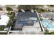 An aerial view showcases the pool, the surrounding gravel area and landscaping of this property at 11437 59Th Ter, Seminole, FL 33772