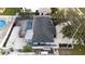 An aerial view captures the pool and screened-in lanai, landscaping, and roof of this property at 11437 59Th Ter, Seminole, FL 33772