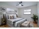 Comfortable bedroom featuring neutral tones, a ceiling fan, and natural light from two windows at 11437 59Th Ter, Seminole, FL 33772