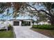 This home offers a garage, landscaping, a curved driveway and well-kept garden beds at 11437 59Th Ter, Seminole, FL 33772