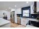 Well-lit kitchen with stainless steel appliances, white cabinets, and a blue tile backsplash at 11437 59Th Ter, Seminole, FL 33772