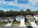 A high angle shot of a blue house situated on a residential street in a vibrant, wooded neighborhood at 11751 Moonsail Dr, Parrish, FL 34219