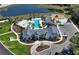 Aerial view of community pool with clubhouse, playground, parking, and lake at 11751 Moonsail Dr, Parrish, FL 34219