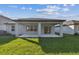 View of outdoor covered patio overlooking green lawn at 11751 Moonsail Dr, Parrish, FL 34219