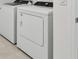 Convenient laundry room with modern, front-loading washer and dryer, offering ease and efficiency at 11751 Moonsail Dr, Parrish, FL 34219