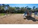 Community playground with wooden play structures, slide, and climbing features for recreation at 11751 Moonsail Dr, Parrish, FL 34219