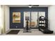 Well-equipped home gym featuring modern exercise equipment, a full-length mirror, and a spacious workout area at 11857 Blue Diamond Trl, Parrish, FL 34219